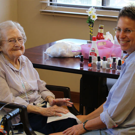 Volunteer - a volunteer painting the nails of a resident